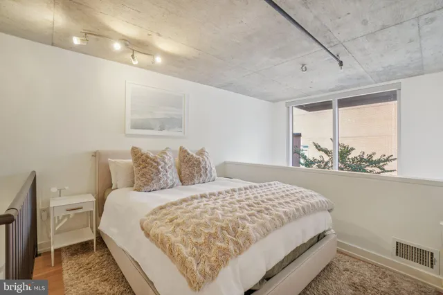 a bedroom with a large bed and a window