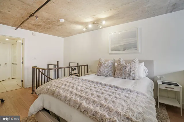 a bedroom with a large bed and a chandelier