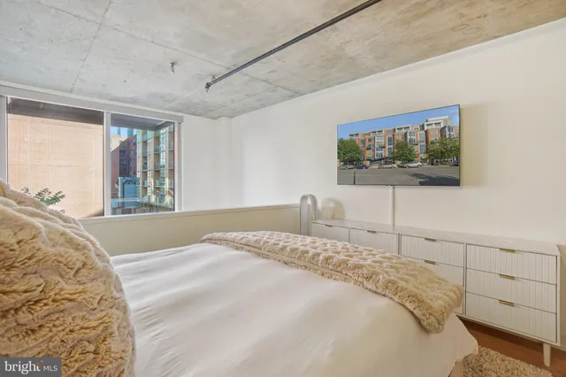 a bedroom with a bed and a flat screen tv