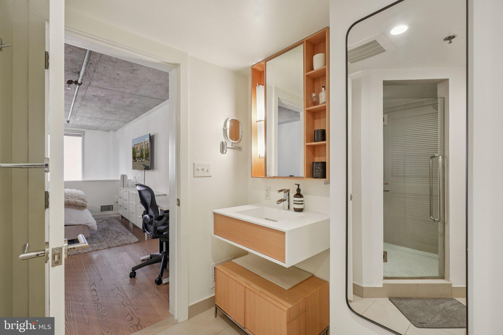 1515 15th Street Northwest, Unit 206 Washington, DC 20005 - Photo 18 of 32 a bathroom with a tub sink and mirror