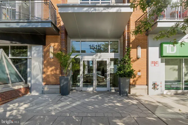 a view of a building with a door and a car parked