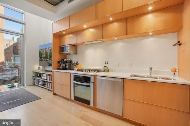 a kitchen with a sink cabinets and appliances