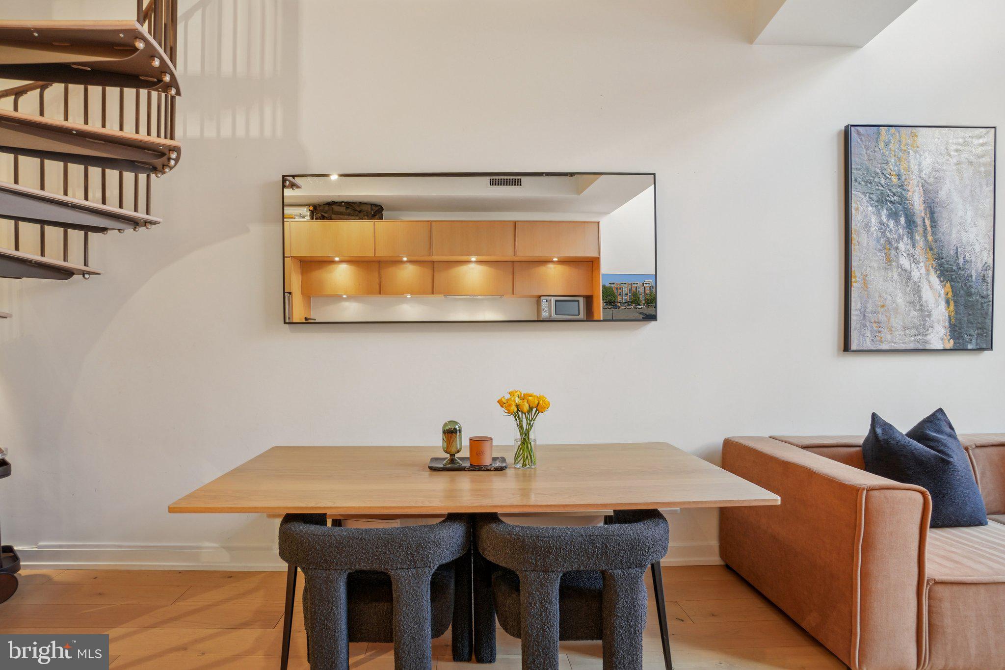 1515 15th Street Northwest, Unit 206 Washington, DC 20005 - Photo 4 of 32 a view of a dining room with furniture and wooden floor
