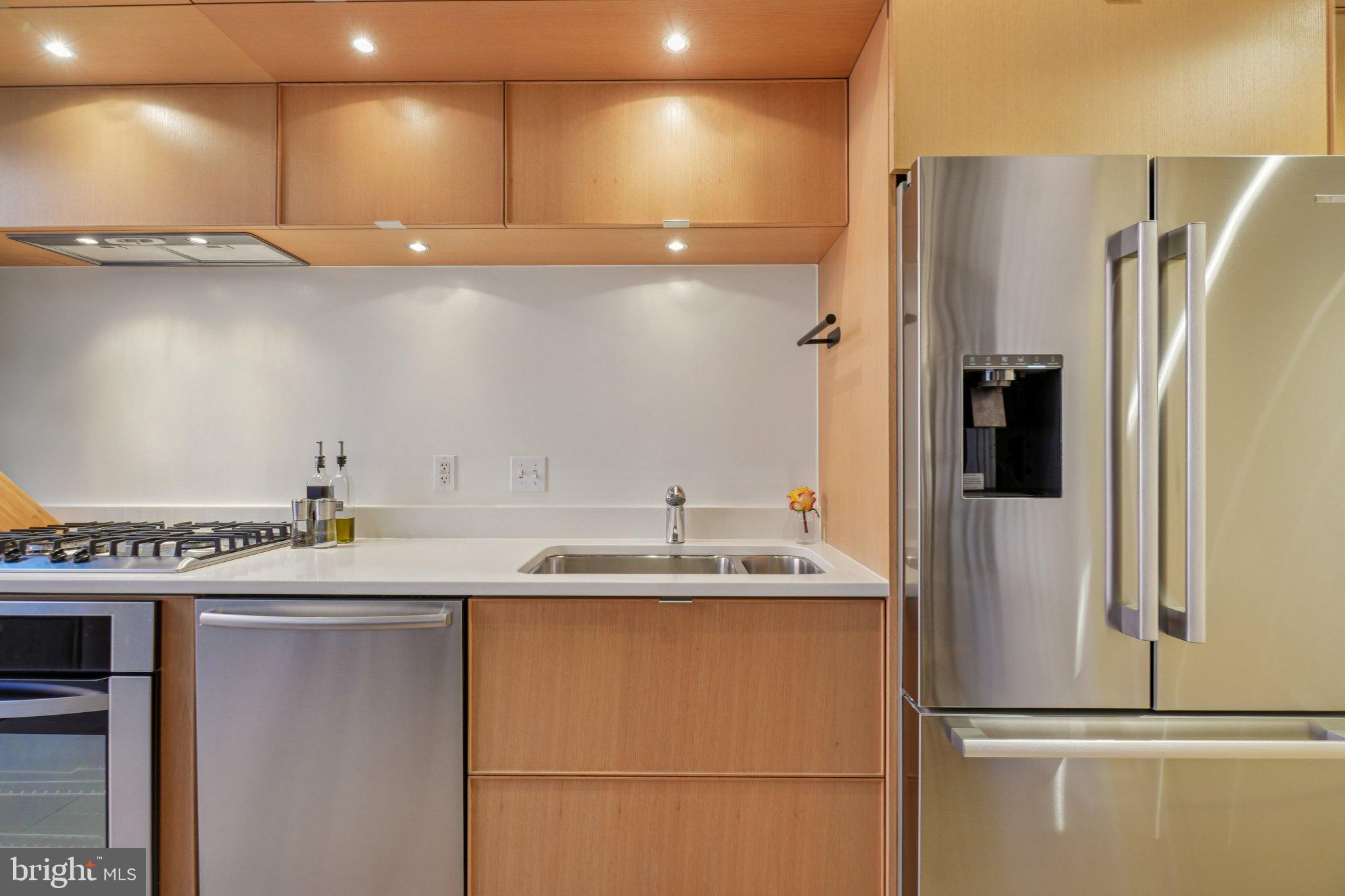 1515 15th Street Northwest, Unit 206 Washington, DC 20005 - Photo 7 of 32 a kitchen with stainless steel appliances granite countertop a refrigerator and a sink
