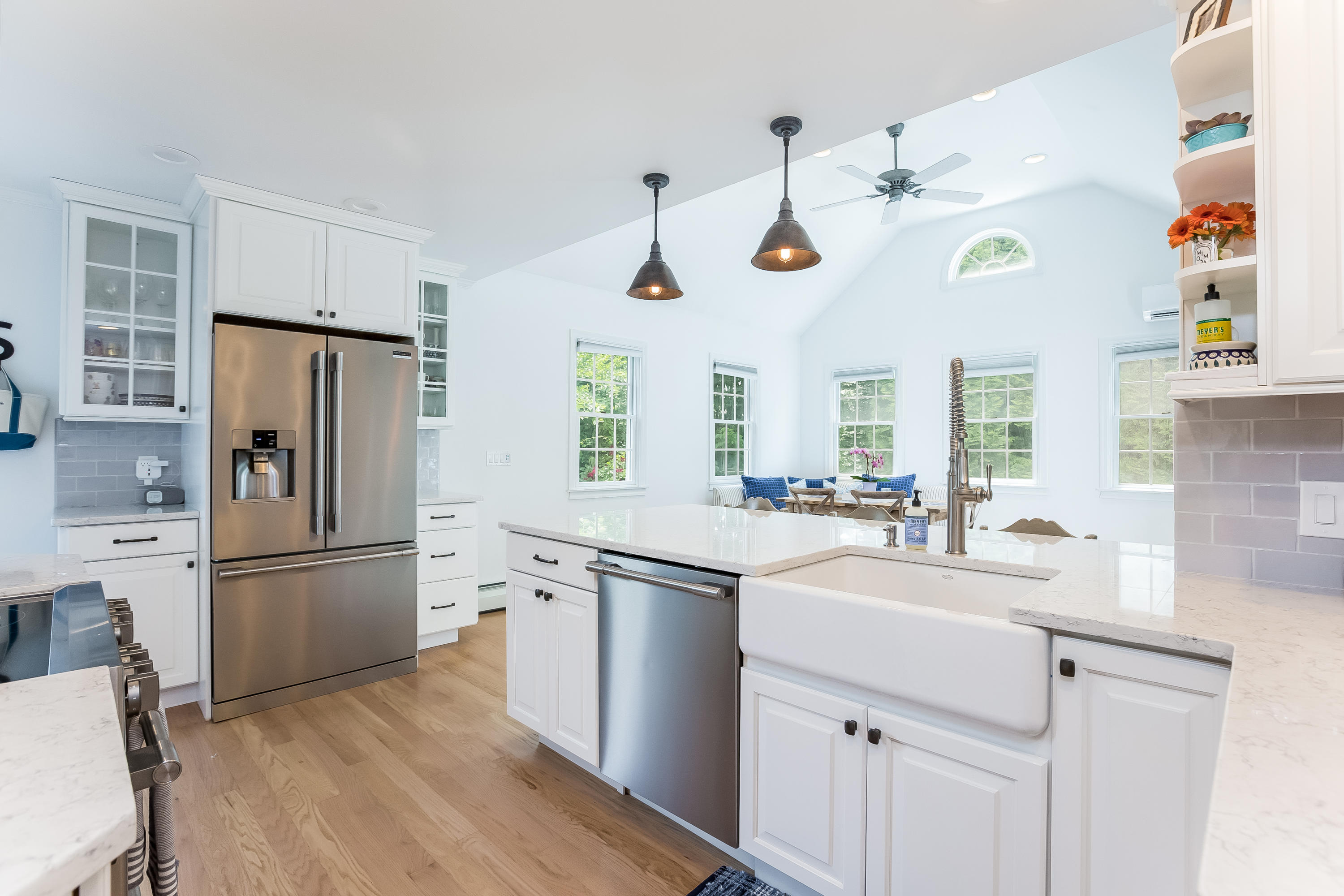 82 Linden Avenue Darien, CT 06820 - Photo 11 of 28 a kitchen with a refrigerator a sink dishwasher a dining table and chairs with wooden floor