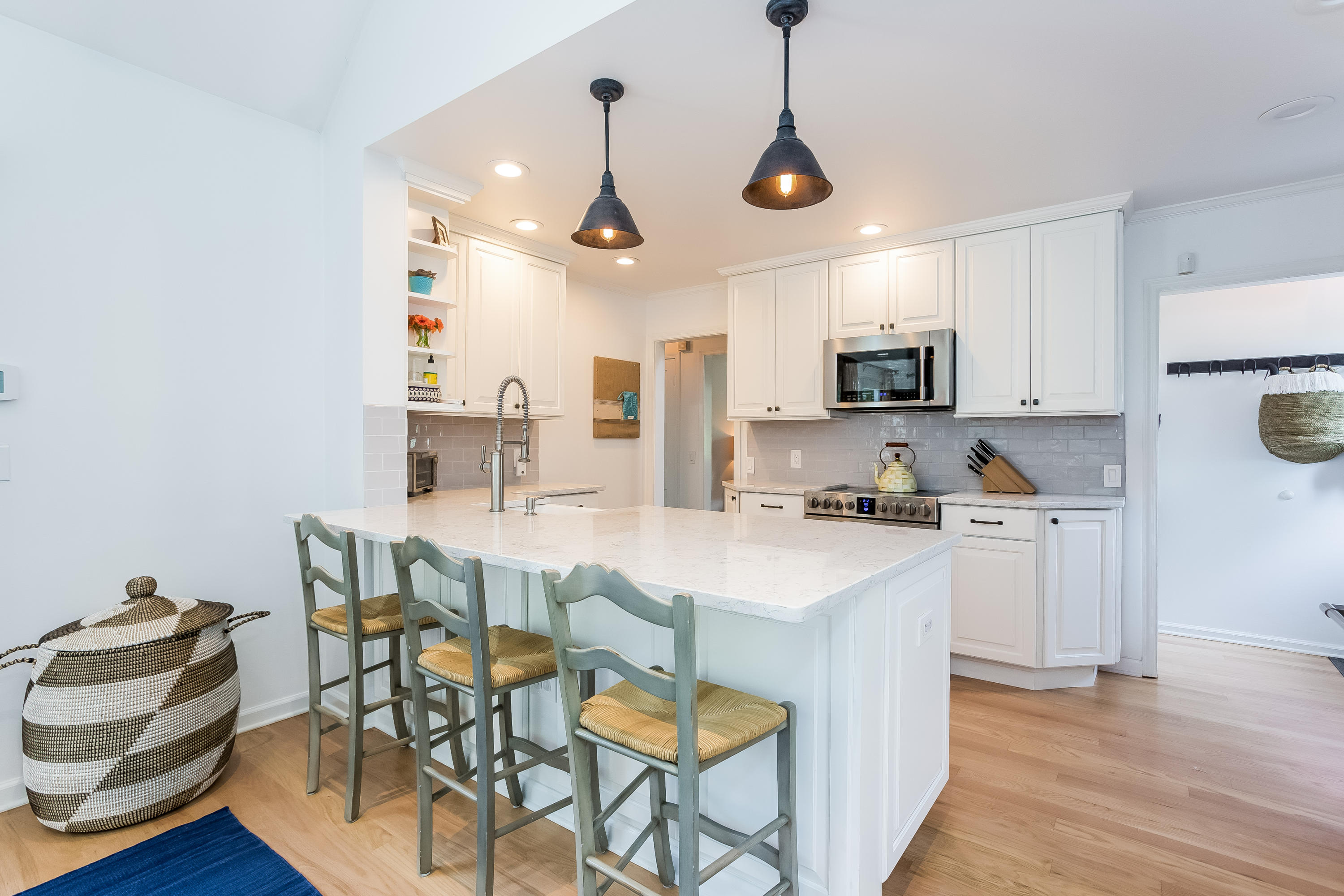 82 Linden Avenue Darien, CT 06820 - Photo 12 of 28 a kitchen with kitchen island a stove a table and chairs in it