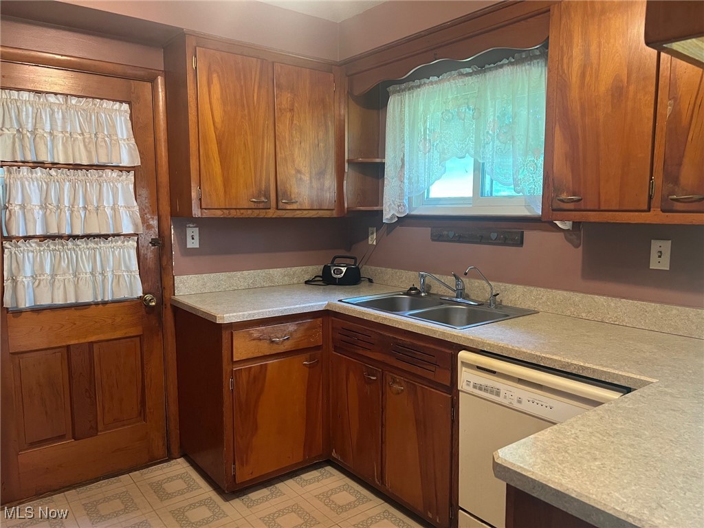 10504 Mulberry Road Chardon, OH 44024 - Photo 17 of 23 Kitchen with dishwasher, light countertops, brown cabinetry