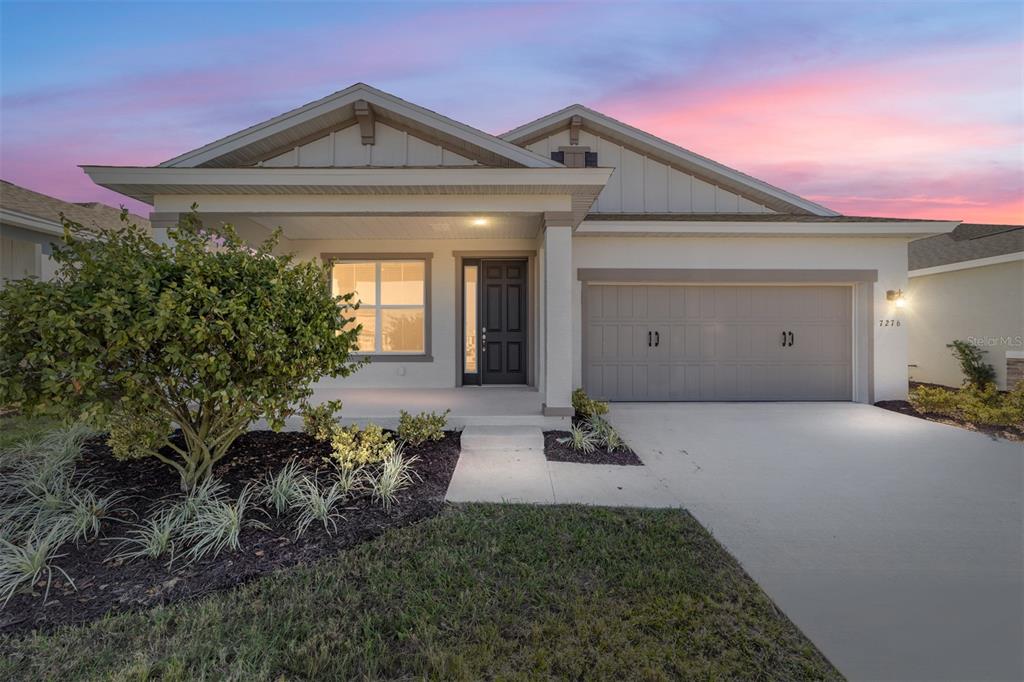 a view of a house with potted plants