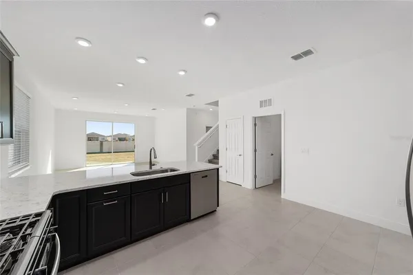 a kitchen with granite countertop a sink and cabinets