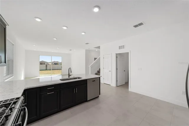 a kitchen with granite countertop a sink and cabinets