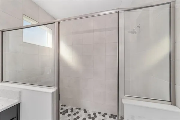 a bathroom with a glass shower door