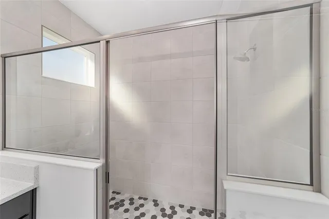 a bathroom with a glass shower door
