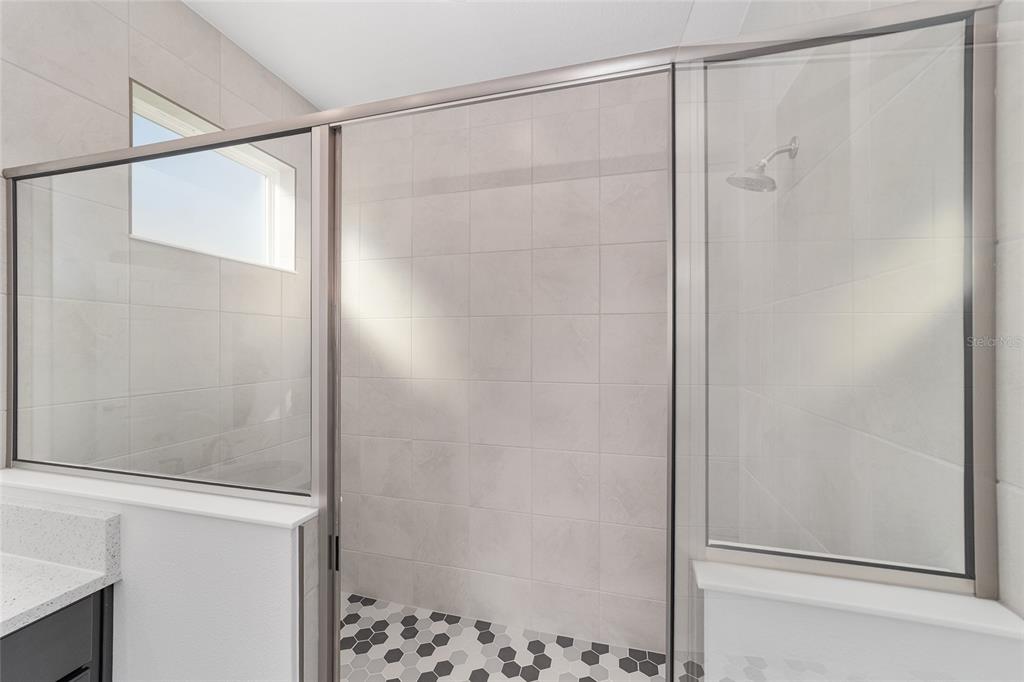 7276 Southwest 58th Place Road Ocala, FL 34474 - Photo 27 of 44 a bathroom with a glass shower door