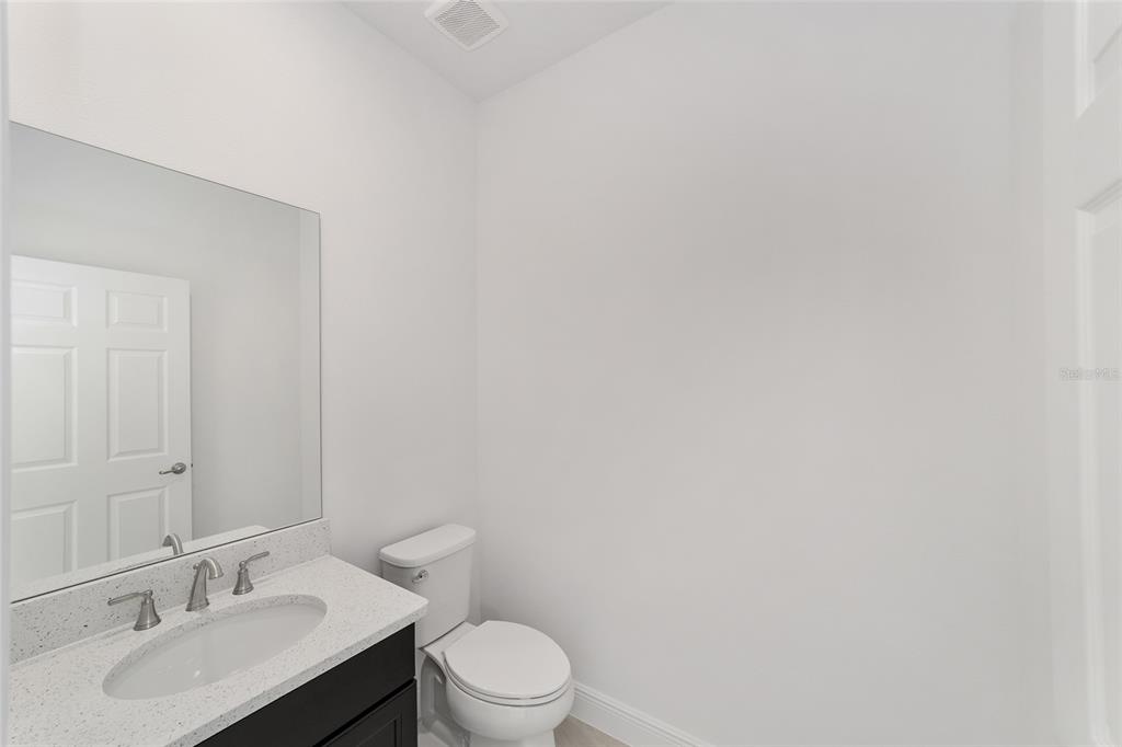 7276 Southwest 58th Place Road Ocala, FL 34474 - Photo 29 of 44 a bathroom with a toilet a sink and mirror