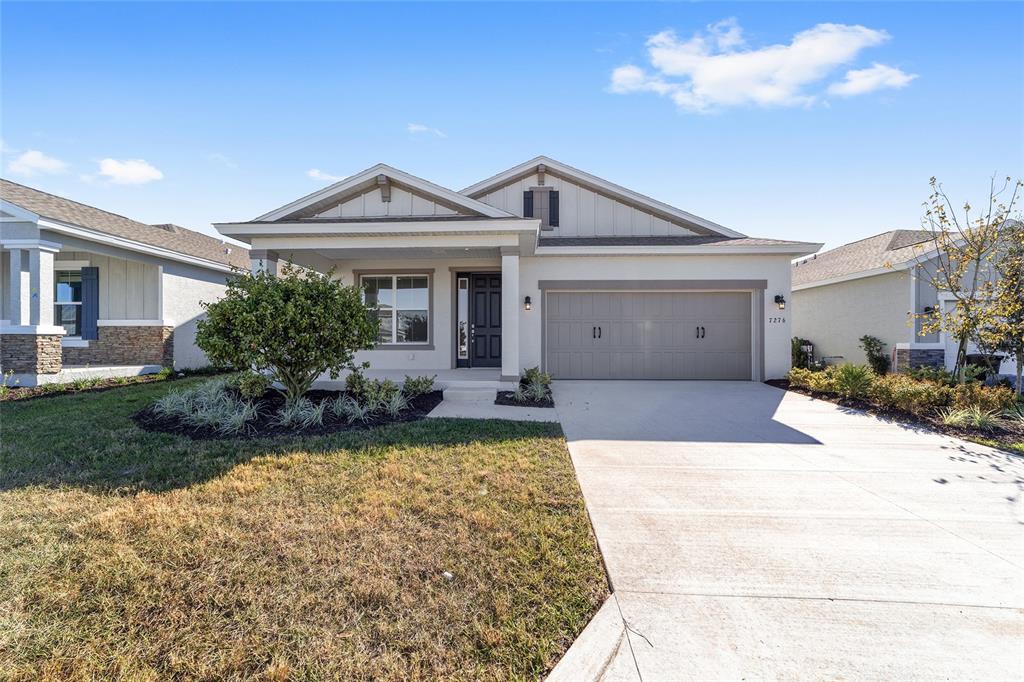 7276 Southwest 58th Place Road Ocala, FL 34474 - Photo 3 of 44 a front view of a house with garden