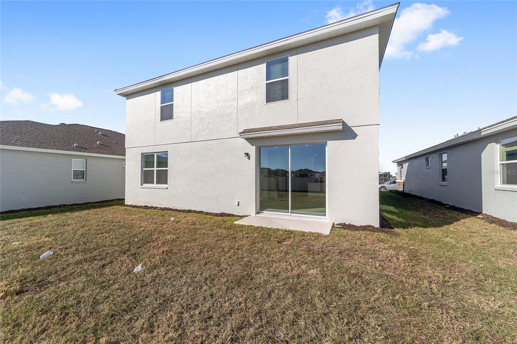 7276 Southwest 58th Place Road Ocala, FL 34474 - Photo 42 of 44 a view of a house with a backyard