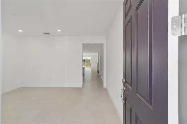 a view of a hallway with wooden shelves