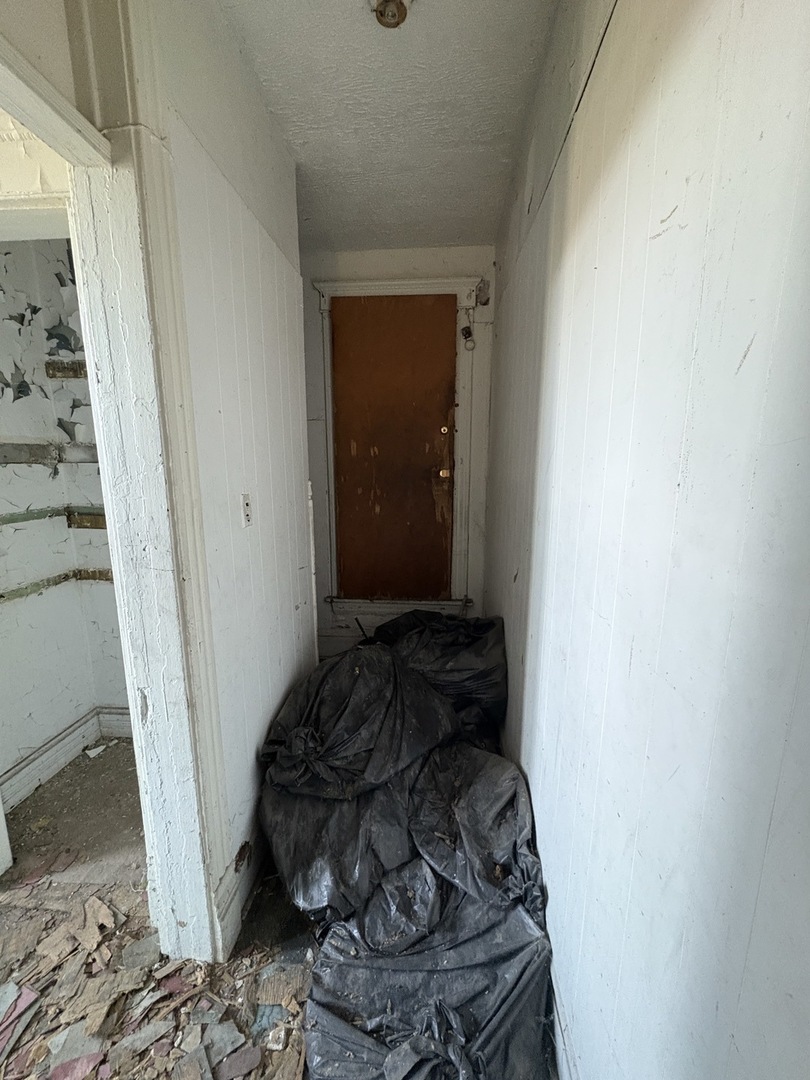 318 West 75th Street Chicago, IL 60621 - Photo 12 of 20 a bedroom with a bed and a window