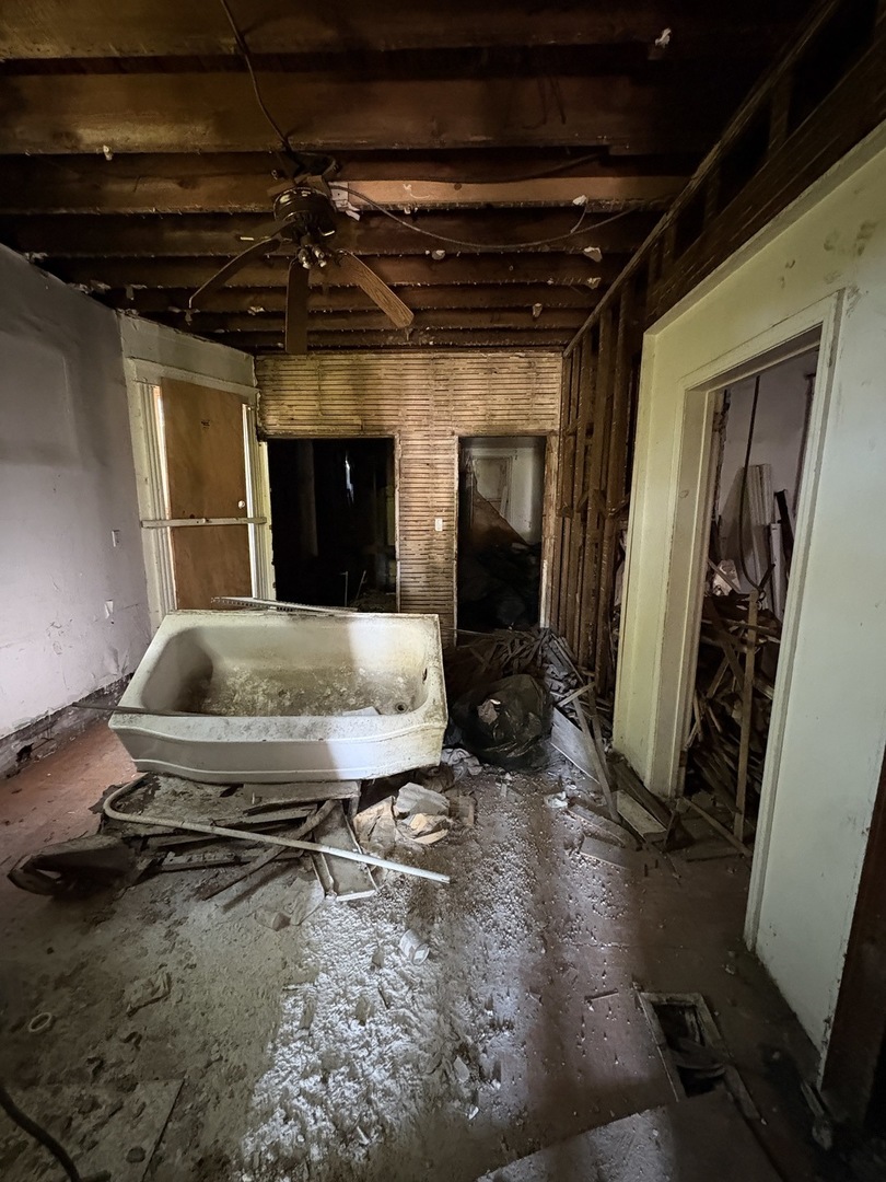 318 West 75th Street Chicago, IL 60621 - Photo 15 of 20 a view of a livingroom with wooden floor and a fireplace
