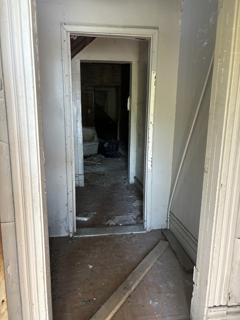 318 West 75th Street Chicago, IL 60621 - Photo 4 of 20 a view of a hallway with a glass door and a window