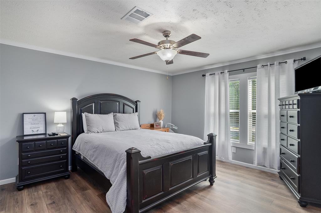 339 Cycle Plant Road Benton, LA 71006 - Photo 20 of 25 a bedroom with a bed a flat tv screen and dresser