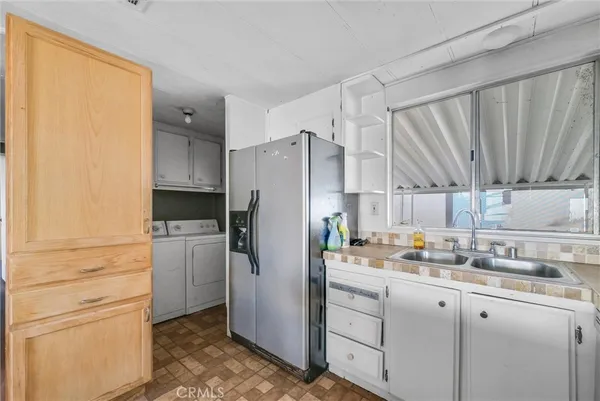 a kitchen with a refrigerator and a sink