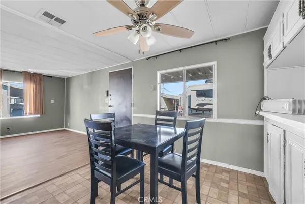 a view of a dining room with furniture and window