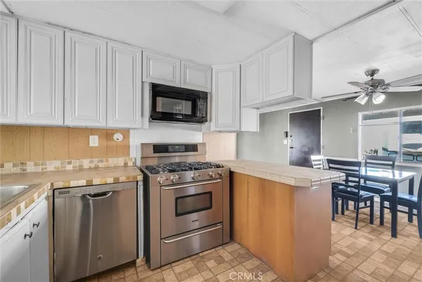 a kitchen with cabinets appliances and a counter space