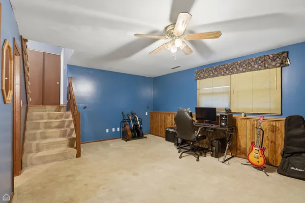 a view of a workspace with furniture and a window