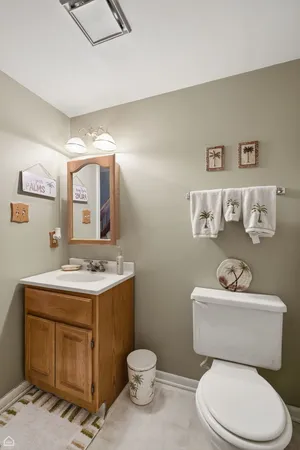 a bathroom with a toilet a sink and mirror
