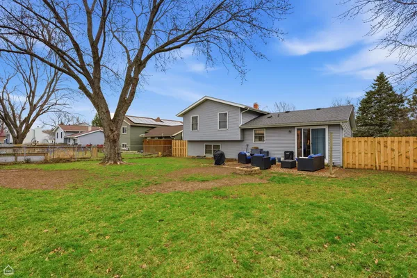 a view of a house with backyard and sitting area