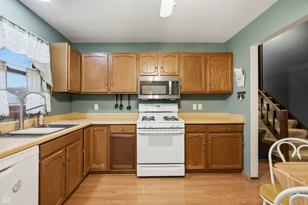 a kitchen with a stove sink and cabinets