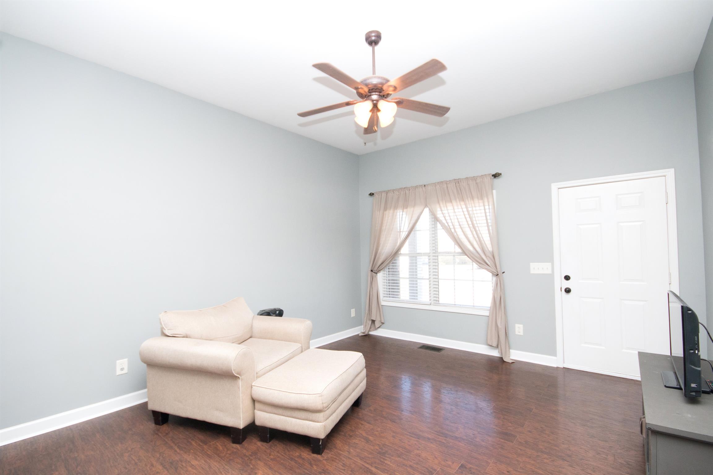 560 Rothwood Avenue Madison, TN 37115 - Photo 7 of 28 a spacious bedroom with a bed and a chandelier