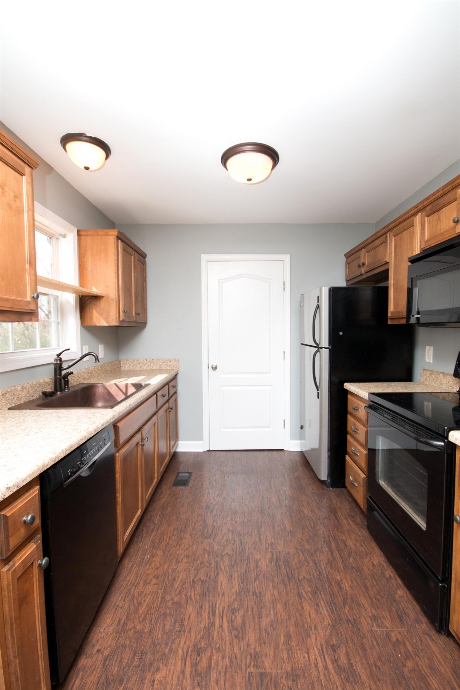 560 Rothwood Avenue Madison, TN 37115 - Photo 8 of 28 a kitchen with a sink cabinets stainless steel appliances and a window