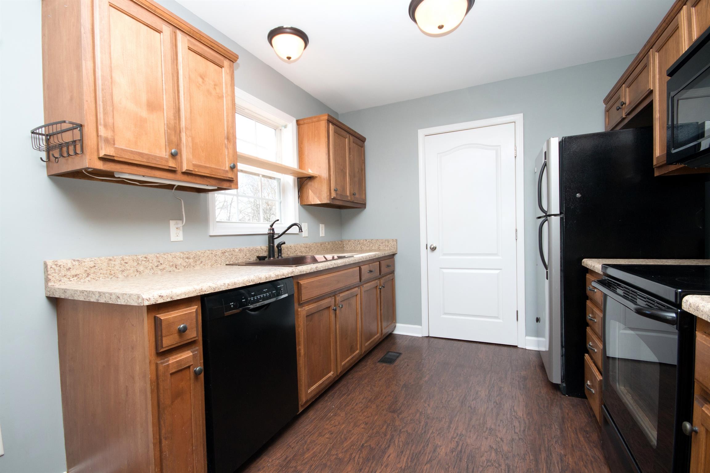 560 Rothwood Avenue Madison, TN 37115 - Photo 9 of 28 a kitchen with stainless steel appliances granite countertop a sink stove and refrigerator