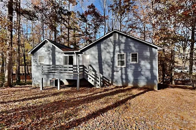 a view of a house with a yard covered in snow