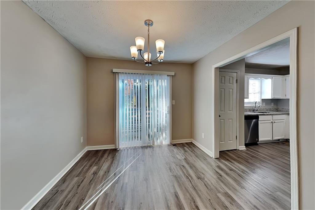 40 Arbor Way Dallas, GA 30157 - Photo 6 of 22 a view of a hallway with wooden floor and a kitchen