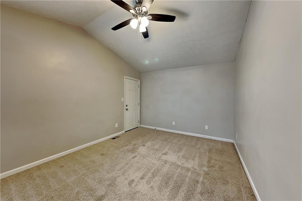 40 Arbor Way Dallas, GA 30157 - Photo 8 of 22 an empty room with a ceiling fan and carpet