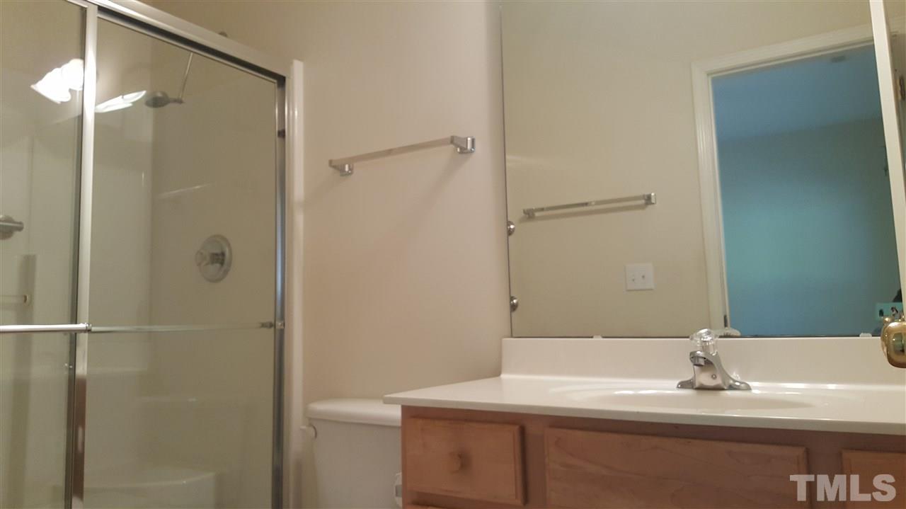 2513 Forest Shadows Lane Raleigh, NC 27614 - Photo 18 of 24 a bathroom with a sink shower and a mirror