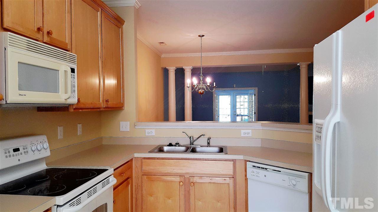 2513 Forest Shadows Lane Raleigh, NC 27614 - Photo 5 of 24 a kitchen with stainless steel appliances granite countertop a sink stove and cabinets