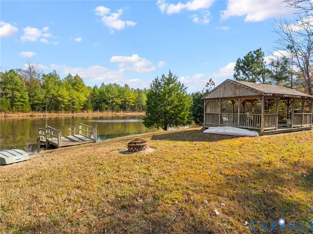 a kitchen with stainless steel appliances granite countertop a sink a counter space and a window