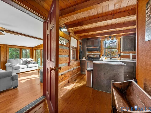 a living room with furniture a flat screen tv and a large window