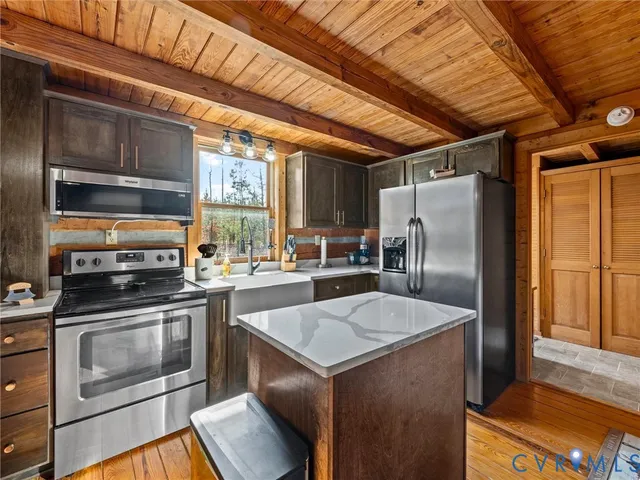a view of a dining room with furniture large windows and wooden floor