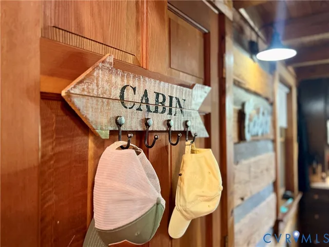 a front view of house with yard outdoor seating and covered with trees