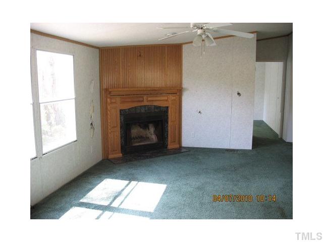 167 Community Road Roxboro, NC 27573 - Photo 2 of 4 a living room with furniture and a fireplace