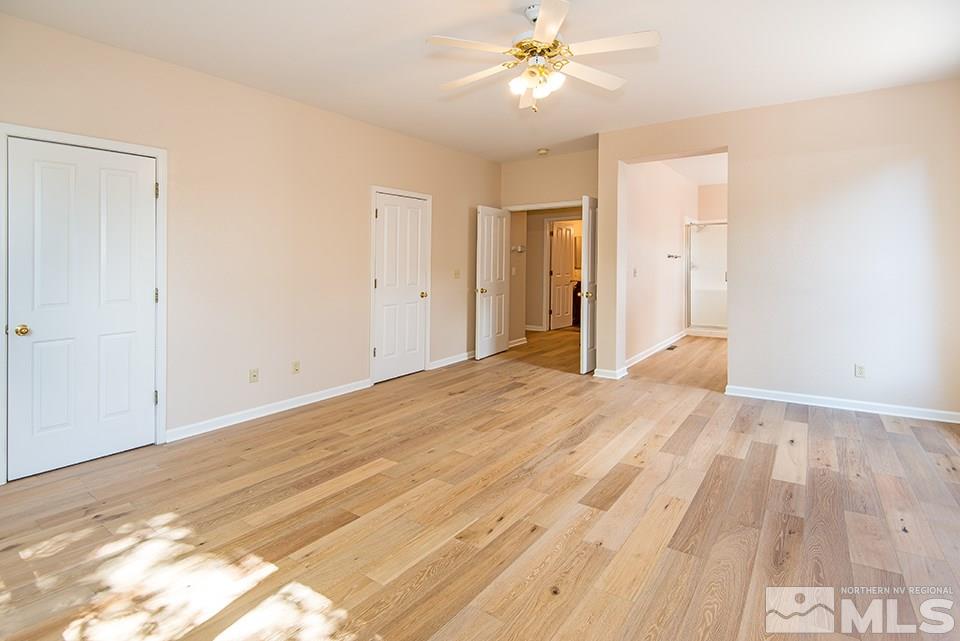 245 Falling Water Court Reno, NV 89519 - Photo 11 of 20 a view of empty room with wooden floor and fan