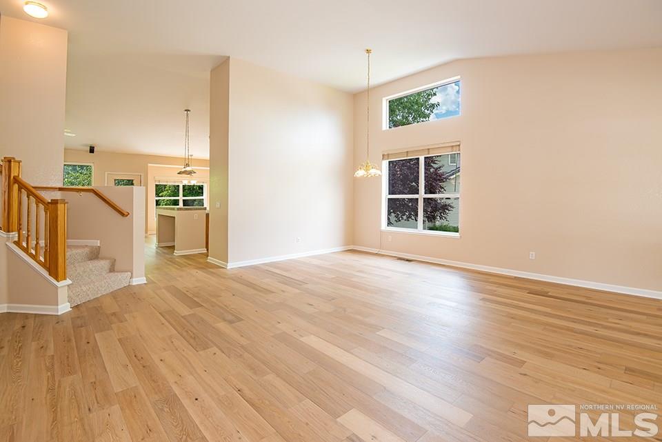 245 Falling Water Court Reno, NV 89519 - Photo 4 of 20 a view of an empty room with wooden floor and a window