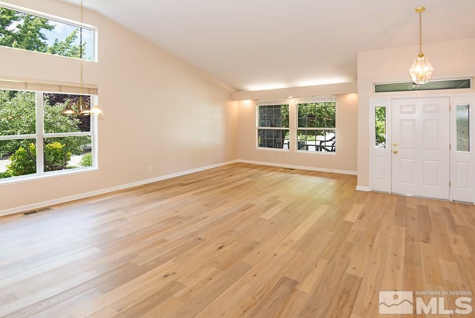 245 Falling Water Court Reno, NV 89519 - Photo 5 of 20 an empty room with wooden floor and windows