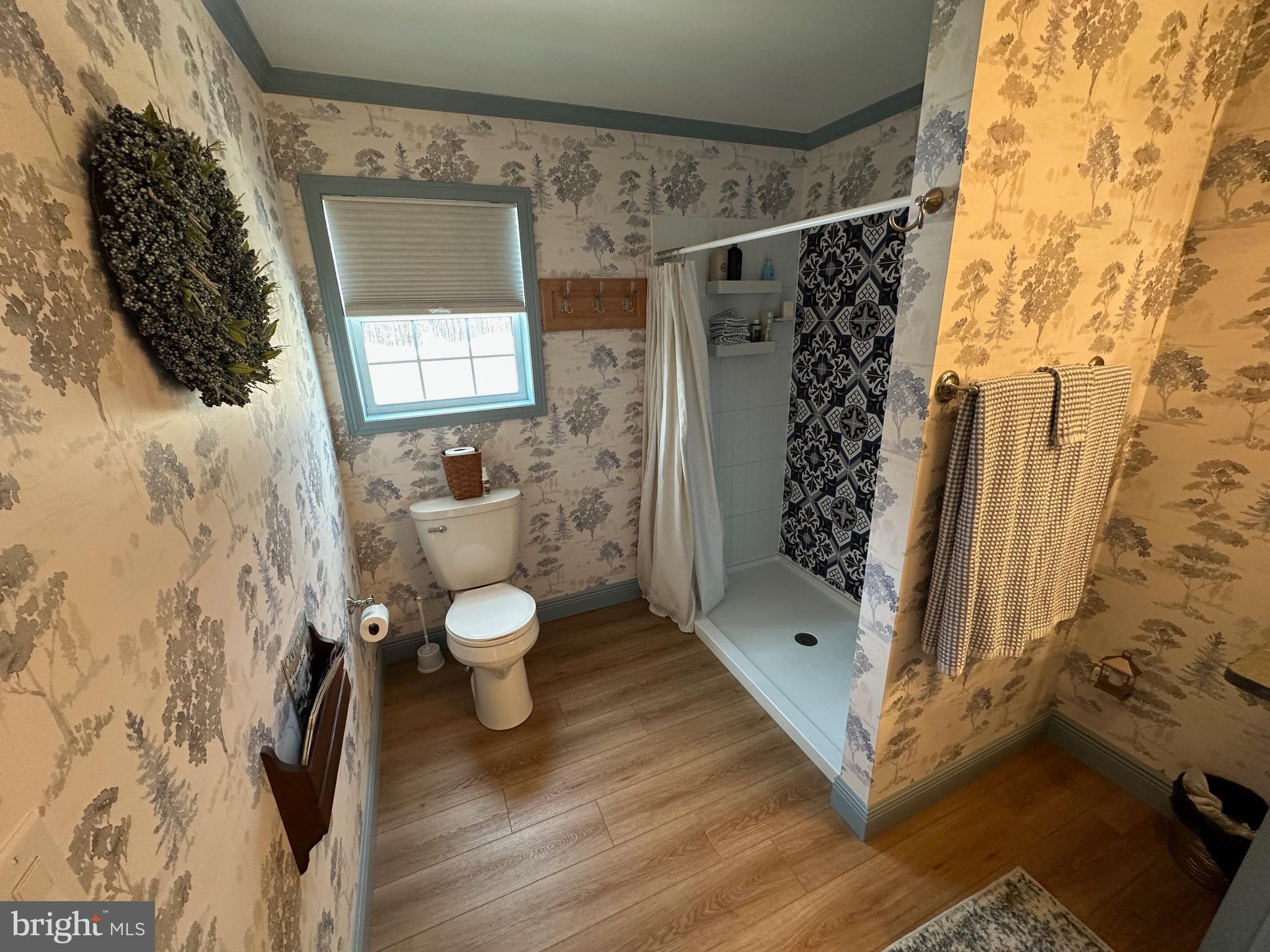 3402 Elk Lick Road Everett, PA 15537 - Photo 29 of 80 a bathroom with a toilet sink and shower curtain