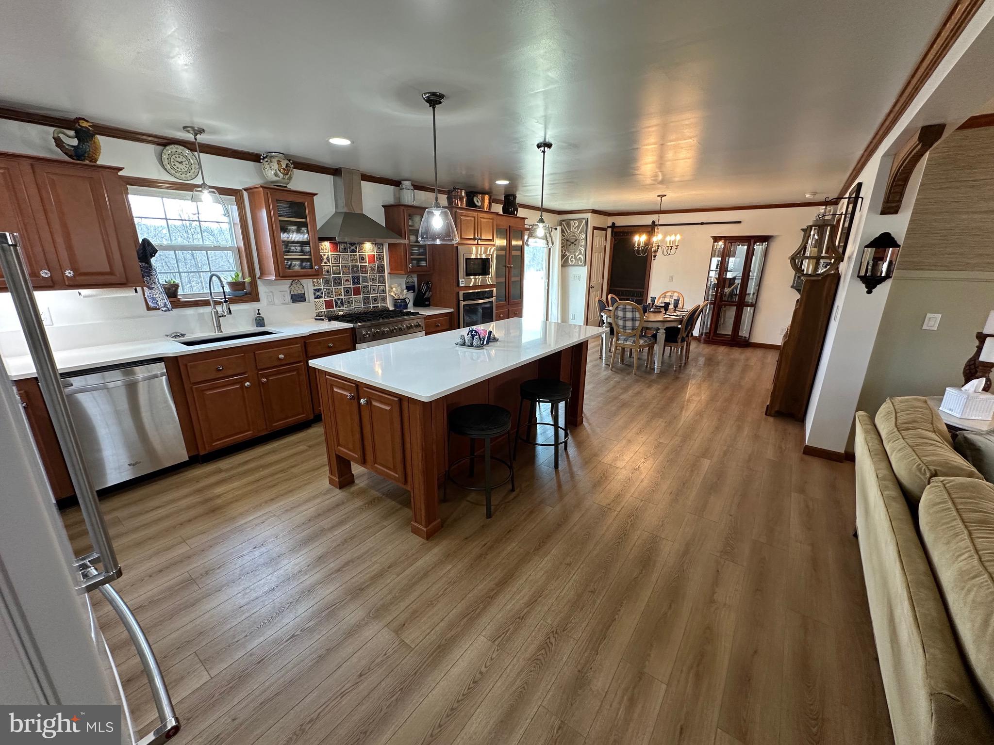 3402 Elk Lick Road Everett, PA 15537 - Photo 7 of 80 a large kitchen with wooden floor and stainless steel appliances